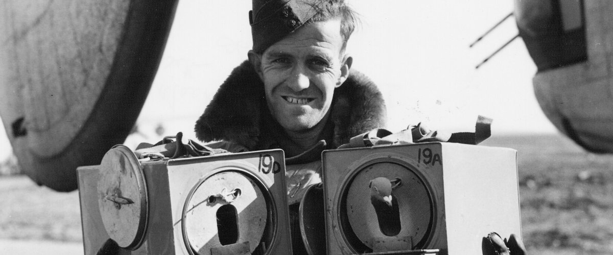 W/O MacKinnon holds two carrier pigeons